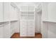 Organized walk-in closet featuring custom shelving, drawers, and hanging rods for ample storage space at 171 Riverview Trl, Roswell, GA 30075