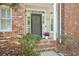 Inviting front entrance with brick steps, shutters, and a gray front door with sidelights at 171 Riverview Trl, Roswell, GA 30075