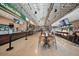 Open food hall with diverse vendors, featuring overhead lighting and dining area at 171 Riverview Trl, Roswell, GA 30075