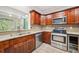 Galley kitchen with stone countertops, stainless appliances, and a wine cooler at 171 Riverview Trl, Roswell, GA 30075