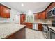 An open kitchen concept with stainless steel appliances and tile flooring at 171 Riverview Trl, Roswell, GA 30075