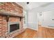 Living room with brick fireplace, hardwood floors, and white trim at 171 Riverview Trl, Roswell, GA 30075