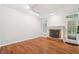 Bright living room with hardwood floors, fireplace, and natural light from large windows at 171 Riverview Trl, Roswell, GA 30075