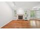 Inviting living room with hardwood floors, a fireplace, and a door leading outside at 171 Riverview Trl, Roswell, GA 30075