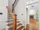 Staircase with wood treads, white risers, and black iron spindles lead to the upper level at 171 Riverview Trl, Roswell, GA 30075