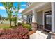 Inviting front porch with stone accents and a view of the landscaped yard at 427 Bluffs View Ln, Canton, GA 30114