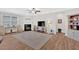 Spacious living room features a cozy fireplace, ceiling fan, and entertainment area with plenty of space for relaxation and entertainment at 427 Bluffs View Ln, Canton, GA 30114
