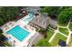 Aerial view of the pool, clubhouse, and a playground, highlighting community amenities at 8935 Muirfield Ct, Duluth, GA 30097