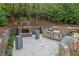 Outdoor kitchen area with stone fireplace, grill and bar, perfect for entertaining at 8935 Muirfield Ct, Duluth, GA 30097