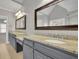 Double vanity in the bathroom with granite counters and gray cabinets at 8935 Muirfield Ct, Duluth, GA 30097