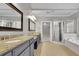 Bathroom showcases double vanity, shower, tub, and tile flooring at 8935 Muirfield Ct, Duluth, GA 30097