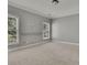 Spacious bedroom with neutral carpet, grey walls, and light trim details at 8935 Muirfield Ct, Duluth, GA 30097