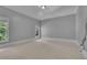 Comfortable bedroom featuring two windows and neutral walls with carpet floors at 8935 Muirfield Ct, Duluth, GA 30097