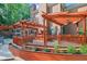 Relaxing outdoor deck features pergola, outdoor lighting, and lush landscaping at 8935 Muirfield Ct, Duluth, GA 30097