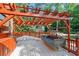 Outdoor deck features covered swing bench, pergola, and bar area at 8935 Muirfield Ct, Duluth, GA 30097