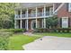 Charming brick home featuring a covered front porch, well-kept lawn, and decorative landscaping at 8935 Muirfield Ct, Duluth, GA 30097