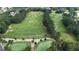 A beautiful aerial of the golf course with manicured lawns surrounded by lush trees in a lovely community at 8935 Muirfield Ct, Duluth, GA 30097