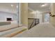 Upstairs hallway featuring wooden rails and access to multiple bedrooms with carpeted floors at 8935 Muirfield Ct, Duluth, GA 30097