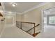 Upstairs hallway featuring wooden rails, carpet floors and neutral walls with white trim at 8935 Muirfield Ct, Duluth, GA 30097