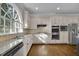 Bright kitchen with stainless steel appliances, granite countertops, and a large arched window at 8935 Muirfield Ct, Duluth, GA 30097