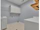 Laundry room with cabinets, utility sink and tile flooring at 8935 Muirfield Ct, Duluth, GA 30097