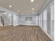 Open-concept living room with hardwood floors, recessed lighting, and ample natural light at 8935 Muirfield Ct, Duluth, GA 30097