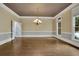 Bright living room showcasing hardwood floors, neutral walls, and a modern chandelier at 8935 Muirfield Ct, Duluth, GA 30097