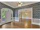 Well-lit living room boasting gorgeous hardwood floors and a stylish doorway leading to another room at 8935 Muirfield Ct, Duluth, GA 30097