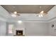 Inviting living room featuring a fireplace and tray ceiling with dual fans at 8935 Muirfield Ct, Duluth, GA 30097