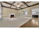 Spacious living room boasts coffered ceilings, fireplace, and seamless flow to the kitchen at 8935 Muirfield Ct, Duluth, GA 30097