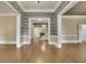 Expansive living area featuring gleaming hardwood floors and decorative wallpaper at 8935 Muirfield Ct, Duluth, GA 30097