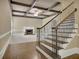 Elegant staircase connects to a spacious living room with a cozy fireplace and coffered ceiling at 8935 Muirfield Ct, Duluth, GA 30097