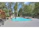 Backyard features a large swimming pool, hot tub, and lush landscaping at 8935 Muirfield Ct, Duluth, GA 30097
