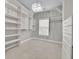 Bright walk-in closet with built-in shelving and drawers for ample storage at 8935 Muirfield Ct, Duluth, GA 30097
