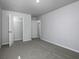 A gray bedroom features an open closet and neutral gray carpet at 250 Shawnee Trl, Dallas, GA 30157