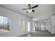 View of the open living room with a ceiling fan and views to the kitchen at 250 Shawnee Trl, Dallas, GA 30157