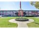 A well-maintained brick building with a manicured lawn, walkway, and a central flag display at 1261 Caroline St # 211, Atlanta, GA 30307