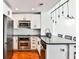 Modern kitchen with stainless steel appliances, white cabinets, and a breakfast bar at 1261 Caroline St # 211, Atlanta, GA 30307