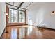 Spacious living room featuring exposed brick, hardwood floors, and large windows at 1261 Caroline St # 211, Atlanta, GA 30307