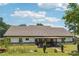 Rear exterior view of home showcasing a covered patio and spacious backyard on a sunny day at 1369 Sierra Ridge Pl, Loganville, GA 30052