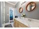 A modern bathroom with double vanity, marble countertop, framed mirrors, and a glass shower at 1369 Sierra Ridge Pl, Loganville, GA 30052