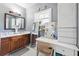 Bathroom featuring a double sink vanity, marble countertops and tiled floors with mirrors and vanity at 1369 Sierra Ridge Pl, Loganville, GA 30052