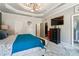 Spacious main bedroom featuring tray ceilings, a television, and an ensuite bathroom with a glass shower at 1369 Sierra Ridge Pl, Loganville, GA 30052
