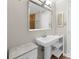 Bathroom featuring a pedestal sink, framed mirror, and tiled shower at 1822 N Rock Springs Ne Rd # 24, Atlanta, GA 30324