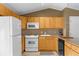 Cozy kitchen with maple cabinets, and appliances, and a breakfast bar, creating a warm and inviting space at 1822 N Rock Springs Ne Rd # 24, Atlanta, GA 30324
