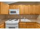 Classic kitchen showcasing wood cabinets, appliances, and ample counter space for easy food preparation at 1822 N Rock Springs Ne Rd # 24, Atlanta, GA 30324