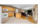 A view of the kitchen and living room with tile flooring, appliances, wood cabinets, and granite countertops at 1822 N Rock Springs Ne Rd # 24, Atlanta, GA 30324