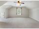 Bright bonus room with large window, ceiling fan, and neutral carpet, perfect for various uses at 183 Applewood Ln, Acworth, GA 30101