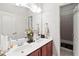 Bright bathroom with double sinks, wooden cabinets, large mirror, and a separate shower/tub area at 50 Cannonade Ct, Covington, GA 30016