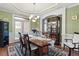 Elegant dining room with wainscoting, stylish lighting, and ample seating for formal gatherings at 50 Cannonade Ct, Covington, GA 30016